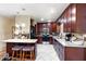 Beautiful kitchen with dark cabinetry, stainless appliances, and a breakfast bar provides ample counter space at 39252 Kimberly Ave, Zephyrhills, FL 33540
