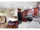 Well-equipped kitchen with dark wood cabinets, granite countertops, and stainless steel appliances offers functionality at 39252 Kimberly Ave, Zephyrhills, FL 33540