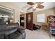 Inviting living area with tile flooring, a comfortable recliner, and a ceiling fan provides relaxation at 39252 Kimberly Ave, Zephyrhills, FL 33540