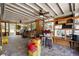 View of covered porch with brick flooring and view to the yard with wood shelving and accessories at 39252 Kimberly Ave, Zephyrhills, FL 33540