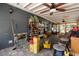 View of covered porch with brick flooring and view to the yard with wood shelving and accessories at 39252 Kimberly Ave, Zephyrhills, FL 33540
