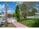 Backyard featuring a waterside patio area with dock, walkway, and signpost at 4315 Flexer Dr, Hernando Beach, FL 34607