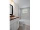 Bathroom featuring a granite sink, white cabinets, and a tiled shower and tub at 4315 Flexer Dr, Hernando Beach, FL 34607