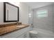 Bathroom featuring a granite sink, white cabinets, and a tiled shower and tub at 4315 Flexer Dr, Hernando Beach, FL 34607