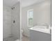 Bathroom with tiled walk-in shower and modern vanity at 4315 Flexer Dr, Hernando Beach, FL 34607