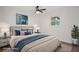 A staged bedroom with a queen bed, ceiling fan, and artwork at 4315 Flexer Dr, Hernando Beach, FL 34607