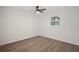 A bright bedroom features wood flooring, a ceiling fan, and a window at 4315 Flexer Dr, Hernando Beach, FL 34607