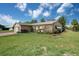 Side view of home showing the lush lawn and established landscaping at 4315 Flexer Dr, Hernando Beach, FL 34607