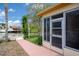 Exterior view of the enclosed lanai and the canal beyond the manicured lawn at 4315 Flexer Dr, Hernando Beach, FL 34607