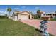 Single-story stucco home with a two-car garage and a unique dolphin mailbox in a sunny neighborhood at 4315 Flexer Dr, Hernando Beach, FL 34607