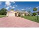 Charming single-story home featuring a spacious driveway and well-maintained landscaping under a sunny blue sky at 4315 Flexer Dr, Hernando Beach, FL 34607