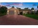 Charming home with a well-maintained lawn and a patterned driveway leading to the garage at 4315 Flexer Dr, Hernando Beach, FL 34607