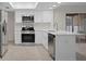 Updated kitchen featuring stainless steel appliances, white cabinets and quartz countertops at 4315 Flexer Dr, Hernando Beach, FL 34607