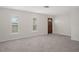 Spacious living area with tiled floors, plantation shutters, and a wood door at 4315 Flexer Dr, Hernando Beach, FL 34607