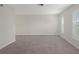 Bright, unfurnished living room with modern tiled floors and plantation shutters on the windows at 4315 Flexer Dr, Hernando Beach, FL 34607