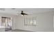 Bright living room featuring sliding glass doors, a ceiling fan, and neutral-toned walls at 4315 Flexer Dr, Hernando Beach, FL 34607
