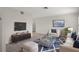 Stylishly furnished living room with a comfortable sofa, glass coffee table, and a modern entertainment center at 4315 Flexer Dr, Hernando Beach, FL 34607