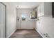 Utility room with modern flooring, water heater and access to backyard at 4315 Flexer Dr, Hernando Beach, FL 34607