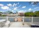 Waterfront patio featuring a white fence, lush landscaping, canal views, and a private dock at 4315 Flexer Dr, Hernando Beach, FL 34607