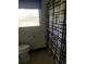 Bathroom featuring a toilet, patterned tile floor, and a black and white geometric shower curtain at 4409 W Wyoming Ave, Tampa, FL 33616