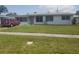 Charming single-story home with a well-maintained lawn and red van parked in the driveway at 4409 W Wyoming Ave, Tampa, FL 33616