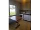Compact kitchen featuring white appliances, light wood cabinets, and an eat-in dining table at 4409 W Wyoming Ave, Tampa, FL 33616
