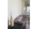 Cozy living room featuring a neutral-toned carpet, sofa, a lamp on a coffee table, and view of hallway at 4409 W Wyoming Ave, Tampa, FL 33616
