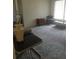 Cozy living room with neutral-toned carpet, lamp, side table, occasional chair, and coffee table at 4409 W Wyoming Ave, Tampa, FL 33616
