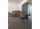 Room featuring boxes, a shelf and a table covered with a decorative cloth at 4409 W Wyoming Ave, Tampa, FL 33616