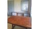 Room featuring large wooden table, storage cabinets and a window providing natural light at 4409 W Wyoming Ave, Tampa, FL 33616