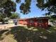 Expansive backyard showcasing the home's exterior, grassy area, and mature trees at 4419 Atwood Dr, Tampa, FL 33610