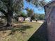 Backyard with a concrete patio, storage sheds, and green trees provides an outdoor living space at 4419 Atwood Dr, Tampa, FL 33610