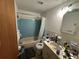 Traditional bathroom featuring blue tile, a bathtub and vanity, and natural lighting at 4419 Atwood Dr, Tampa, FL 33610
