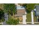 Birds-eye view of the home with mature landscaping and paved driveway at 4700 Chancellor Ne St, St Petersburg, FL 33703