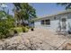 Home's backyard with a paver patio, landscaping, and mature trees at 4700 Chancellor Ne St, St Petersburg, FL 33703