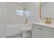 Bright bathroom with white subway tile, patterned floor, and gold accents at 4700 Chancellor Ne St, St Petersburg, FL 33703