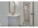 Stylish bathroom featuring shiplap walls, patterned tile floor and modern vanity with a gold faucet and mirror at 4700 Chancellor Ne St, St Petersburg, FL 33703