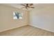 Bedroom features wood-look tile floor, ceiling fan and a large window overlooking the neighborhood at 4700 Chancellor Ne St, St Petersburg, FL 33703
