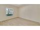 Sunlit bedroom showcasing wood-look tile floor, a large window, and neutral paint at 4700 Chancellor Ne St, St Petersburg, FL 33703