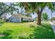 Lovely single-Gathering home with mature tree, lush green lawn, and blue exterior at 4700 Chancellor Ne St, St Petersburg, FL 33703