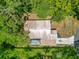 Birds-eye view of a home's roof, surrounded by trees and a grassy yard at 473 Forest Ave, Brooksville, FL 34601