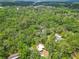 Aerial view showcasing the home's wooded lot and location in a green residential neighborhood at 473 Forest Ave, Brooksville, FL 34601