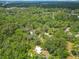 Aerial view of a home surrounded by a dense canopy of trees at 473 Forest Ave, Brooksville, FL 34601