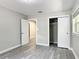This bedroom features gray walls, grey vinyl floors, and a closet at 473 Forest Ave, Brooksville, FL 34601