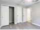 This bedroom features grey vinyl floors, a closet, and modern trim at 473 Forest Ave, Brooksville, FL 34601