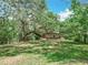 A quaint home is set on a sprawling lot, shaded by an enormous oak tree at 473 Forest Ave, Brooksville, FL 34601