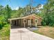 Cozy one-story home with a convenient carport and a shaded front entrance with stylish railing at 473 Forest Ave, Brooksville, FL 34601