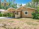 Inviting single-story home featuring a covered carport and a quaint, landscaped front yard at 473 Forest Ave, Brooksville, FL 34601