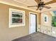 Welcoming front porch featuring a ceiling fan, stylish railing, and convenient access to the entrance at 473 Forest Ave, Brooksville, FL 34601