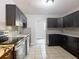 A modern kitchen features sleek black cabinets, granite countertops, and stainless steel appliances at 473 Forest Ave, Brooksville, FL 34601